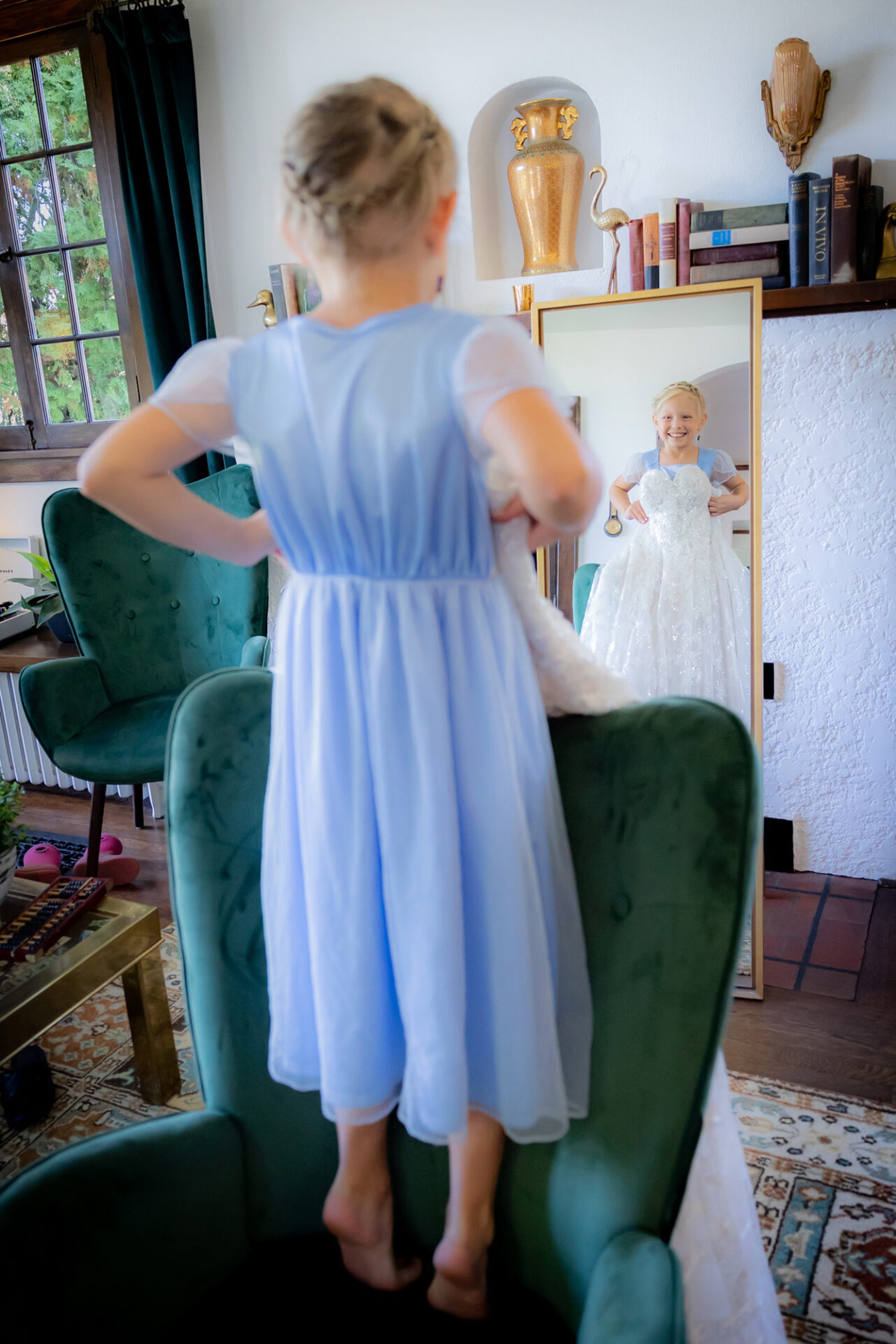 A young girl trying on a wedding gown