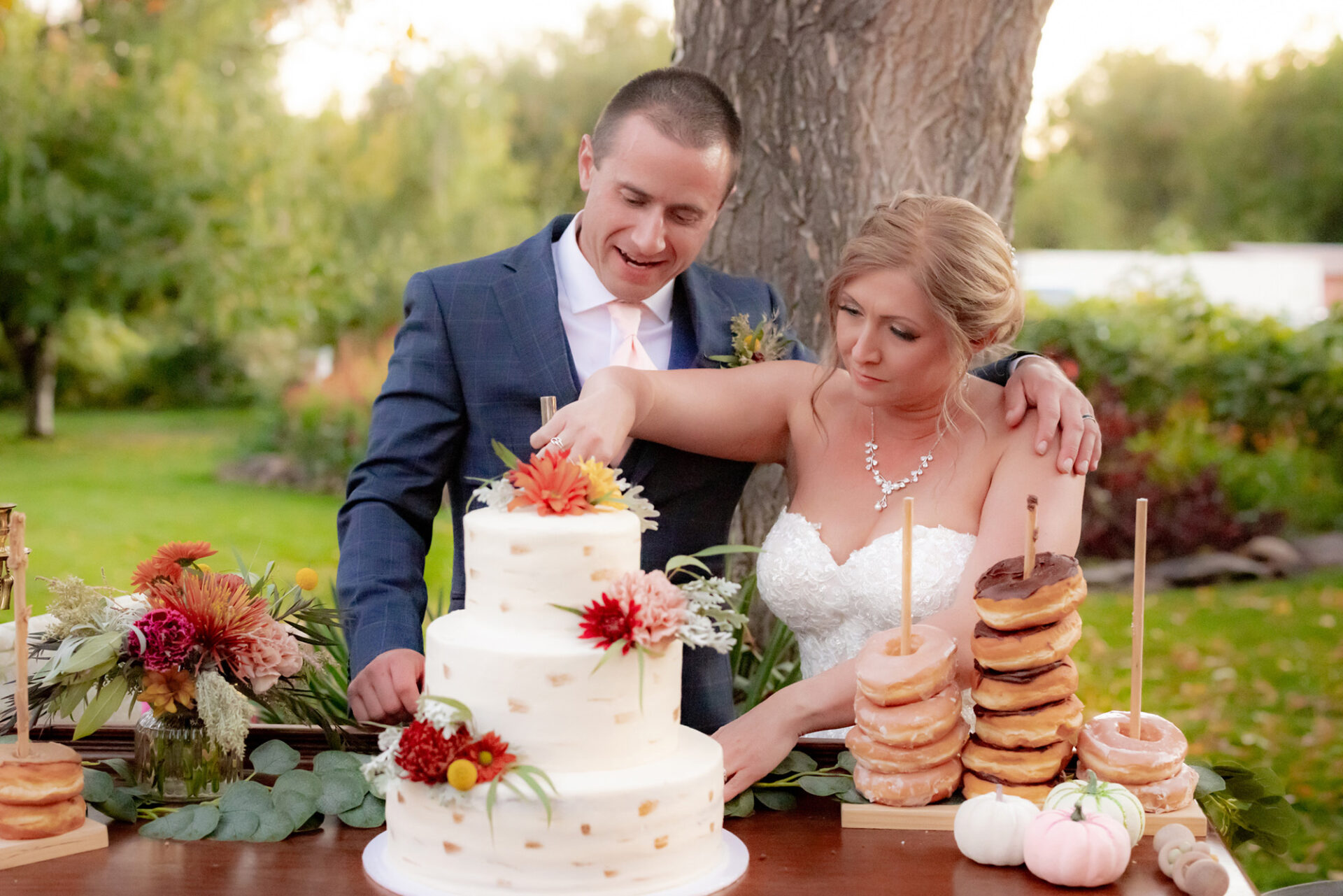 The married couple slicing the wedding cake